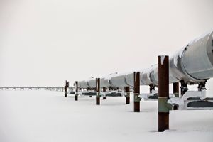 The first mile of the 800-mile Trans-Alaska Pipeline extends across the frozen tundra near the Alyeska Pipeline Services Co. pump station in Prudhoe Bay, Alaska, U.S., on Thursday, Feb. 16, 2017. Four decades after the Trans Alaska Pipeline System went live, transforming the North Slope into a modern-day Klondike, many Alaskans fear the best days have passed. Bloomberg photo by Daniel Acker