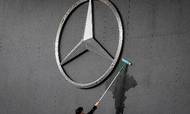 FILE - In this May 9, 2019, file photo a man works on a Mercedes logo at the IAA Auto Show in Frankfurt, Germany. (AP Photo/Michael Probst, File)