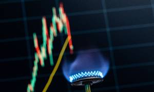 15 June 2022, Baden-Wuerttemberg, Rottweil: A bluish flame from a gas stove is seen in an office in front of a computer screen showing the price of natural gas as a candlestick chart. Photo by: Silas Stein/picture-alliance/dpa/AP Images
