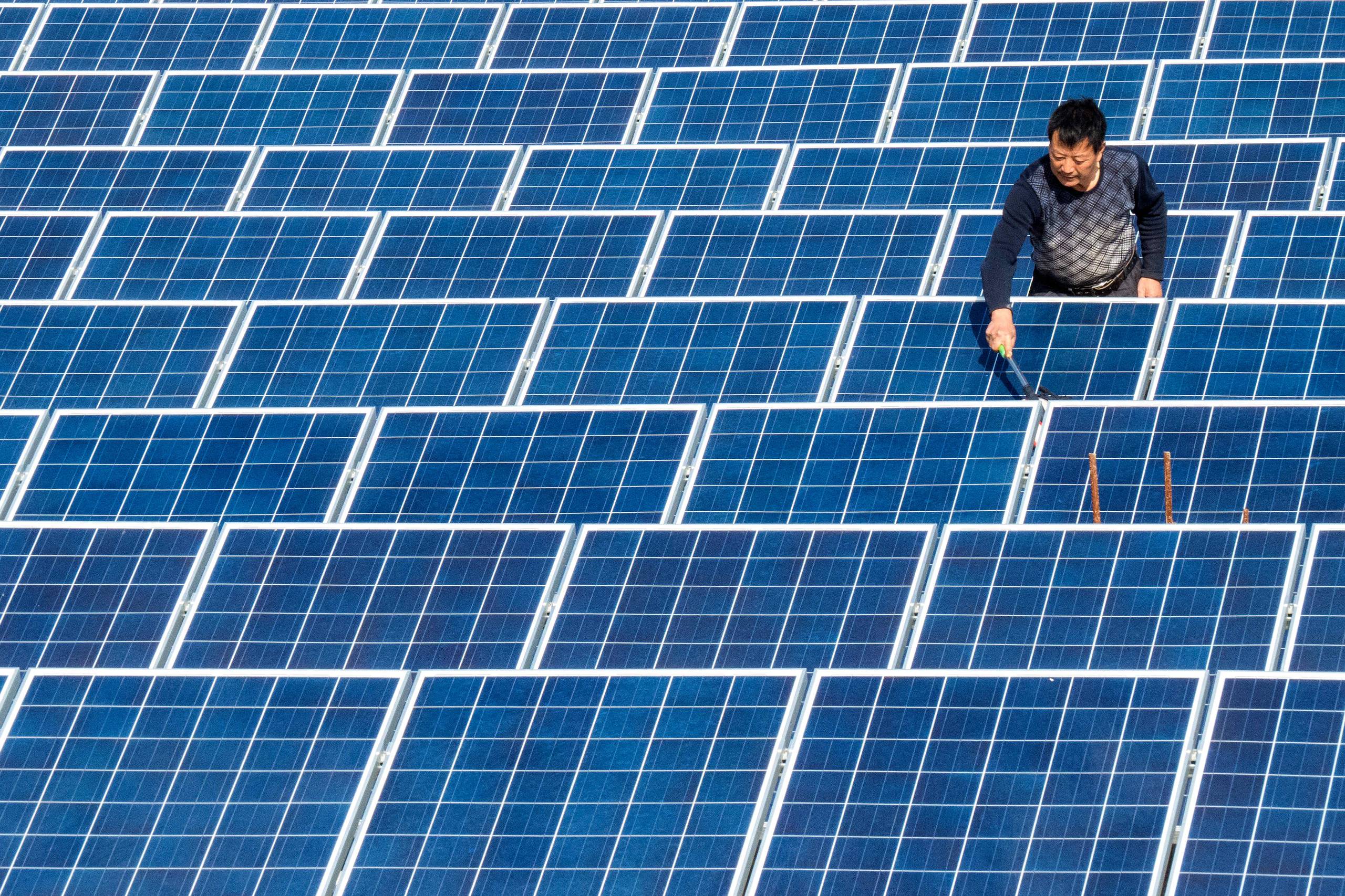 --FILE--A Chinese worker dusts off solar panels at a photovoltaic power station in Maqiao town, Baokang county, Xiangyang city, central China's Hubei province, 20 November 2015. China aims to vastly increase its already world-leading solar capacity by 2020, but it is motivated by more than just fighting climate change. It's worth taking a minute to appreciate the sheer scale of what China is doing in solar right now. In 2015, the country added more than 15 gigawatts of new solar capacity, surpassing Germany as the world's largest solar power market. China now has 43.2 gigawatts of solar capacity, compared with38.4 gigawatts in Germany and 27.8 in the United States. According to new projections, it seems that trend is going to continue. Under its 13th Five Year Plan, China will nearly triple solar capacity by 2020, adding 15 to 20 gigawatts of solar capacity each year for the next five years, according to Nur Bekri, director of the National Energy Administration. That will bring the country's installed solar power to more than 140 gigawatts. To put that in context, world solar capacity topped 200 gigawatts last year and is expected to reach 321 gigawatts by the end of 2016.(Imaginechina via AP Images)