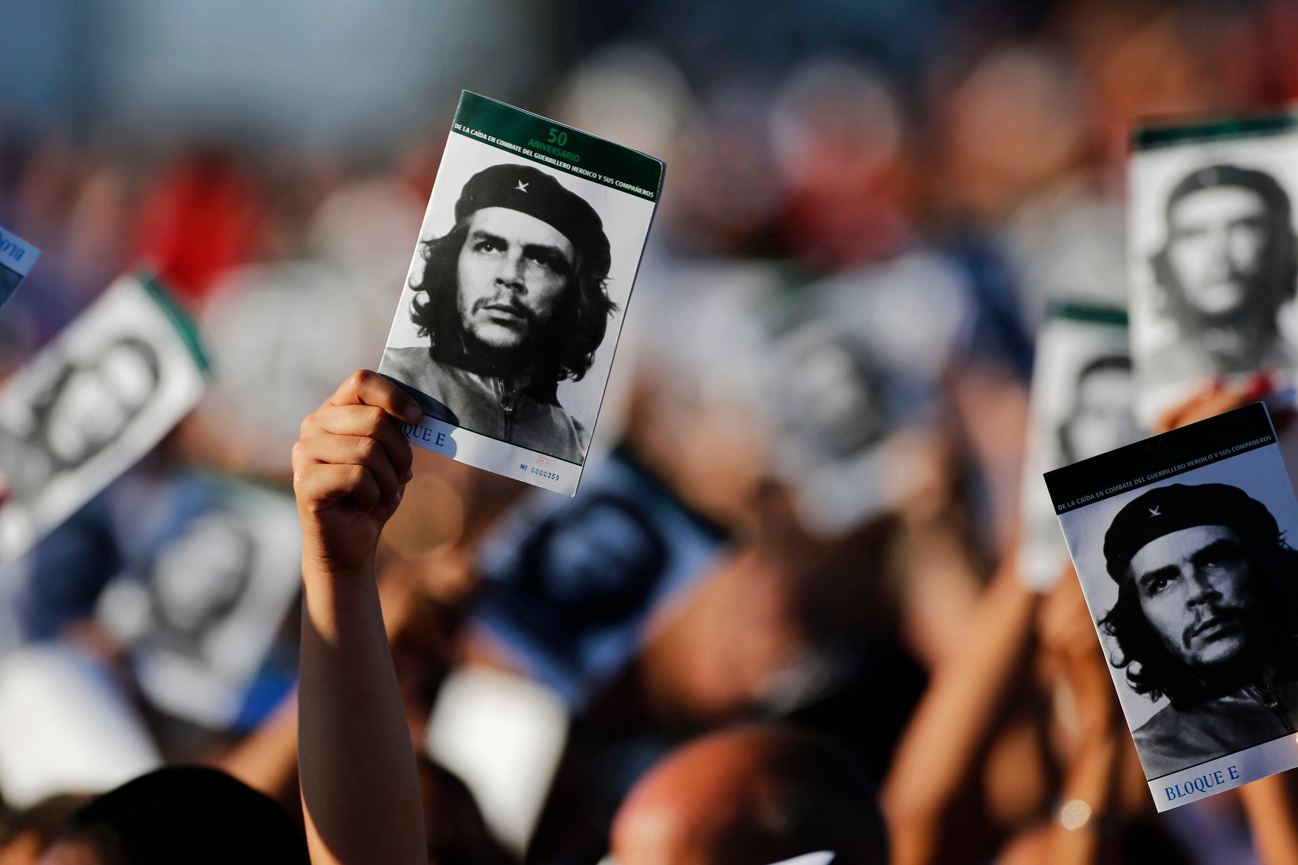People wave pictures at an event paying tribute to Cuban Revolution hero Ernesto “Che” Guevara marking the 50th anniversary of his death in Santa Clara, Cuba, Sunday, Oct. 8, 2017. (AP Photo/Desmond Boylan)